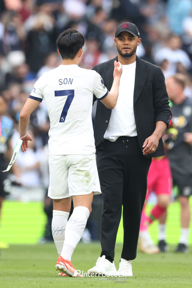 Vincent Kompany, Manager of Burnley, interacts with Son Heung-Min of Tottenham Hotspur
